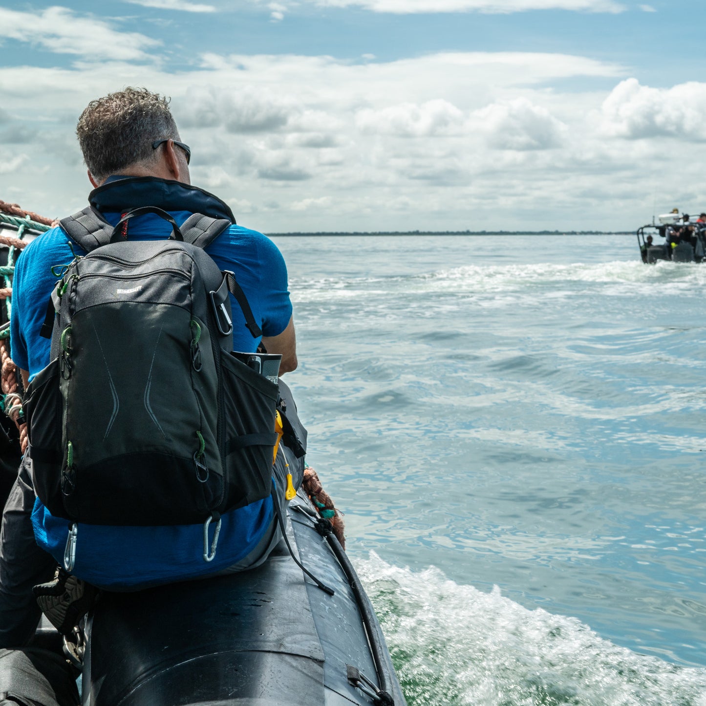 Ian Urbina, author of The Outlaw Ocean, looks out to sea off The Gambian coast while carrying his MindShift TrailScape 18L backpack from Think Tank Photo.