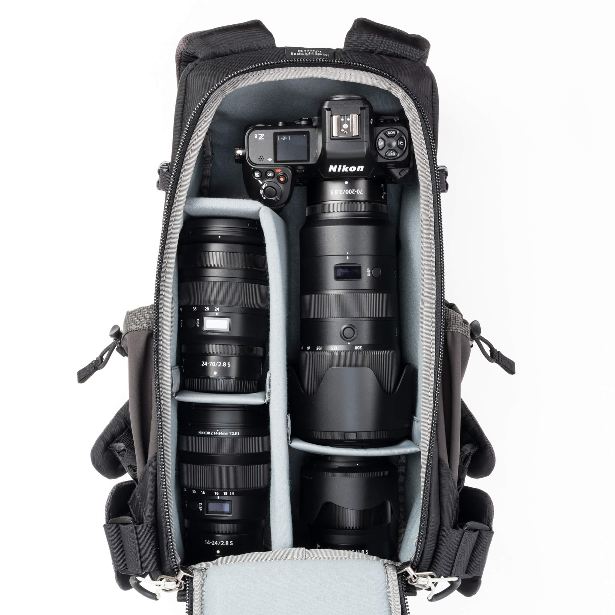 Holds a standard-sized camera body
with lenses attached and 1–3 standard zoom lenses