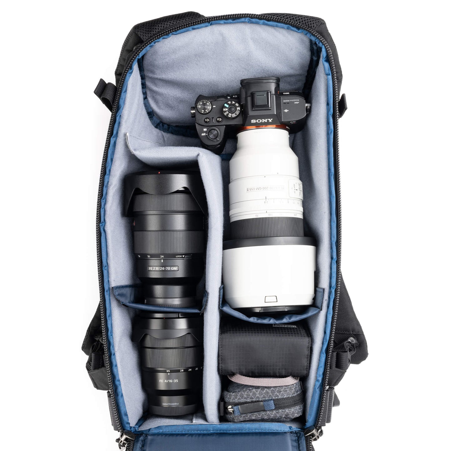 
                  
                    Holds a standard-sized camera body with lenses attached and 1–3
standard zoom lenses
                  
                