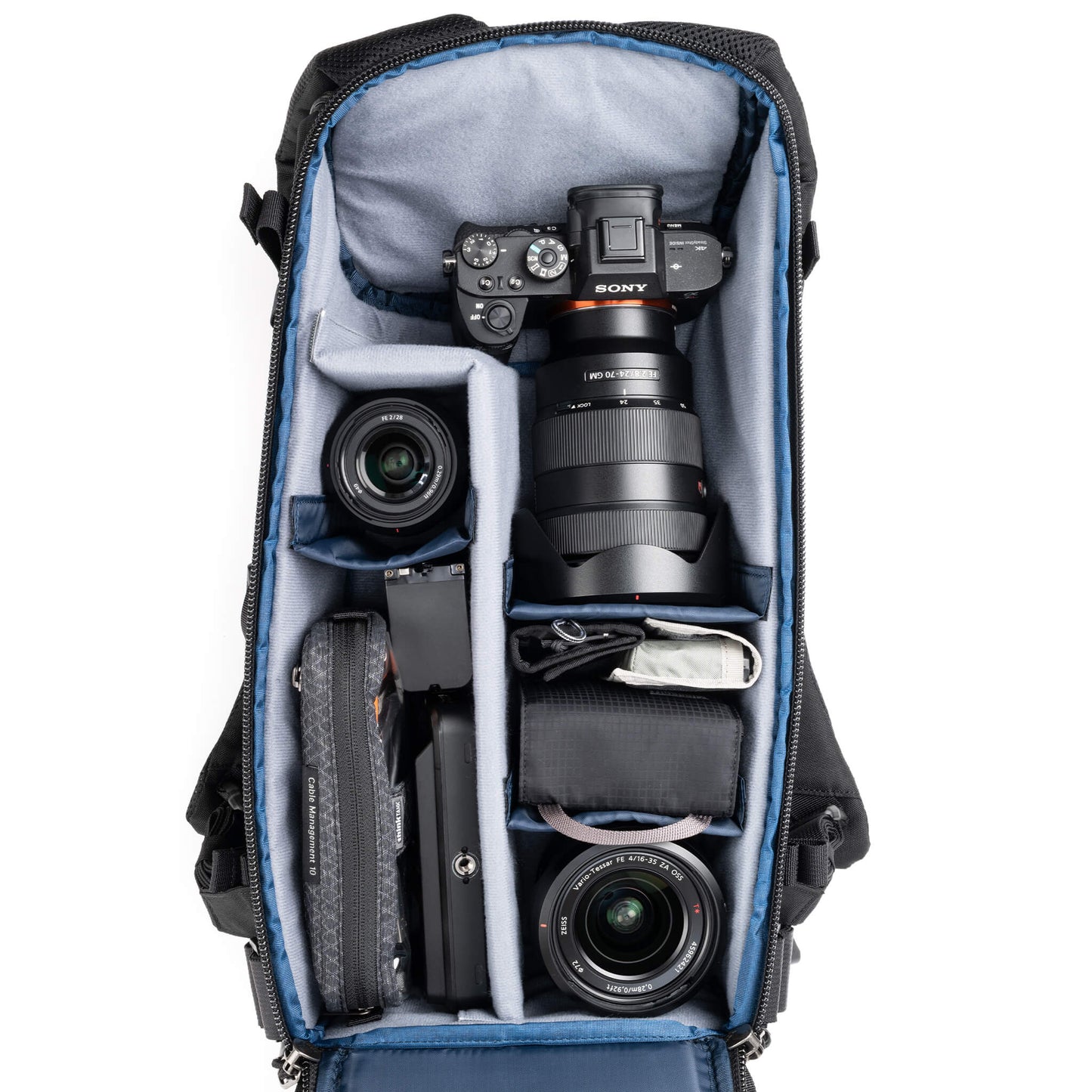 
                  
                    Holds a standard-sized camera body with lenses attached and 1–3
standard zoom lenses
                  
                