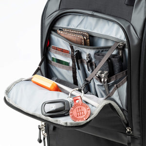 Easily accessible front organizer pocket includes an inner zippered pocket with key lanyard