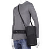 Pouch rotates or locks on a belt. Shoulder Strap included.